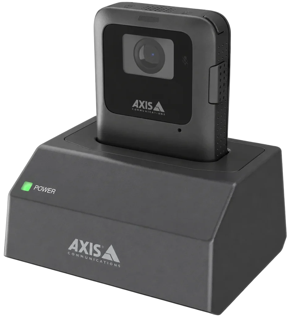 AXIS W702 1-bay docking station charging an AXIS body-worn camera with bright green power indicator.
