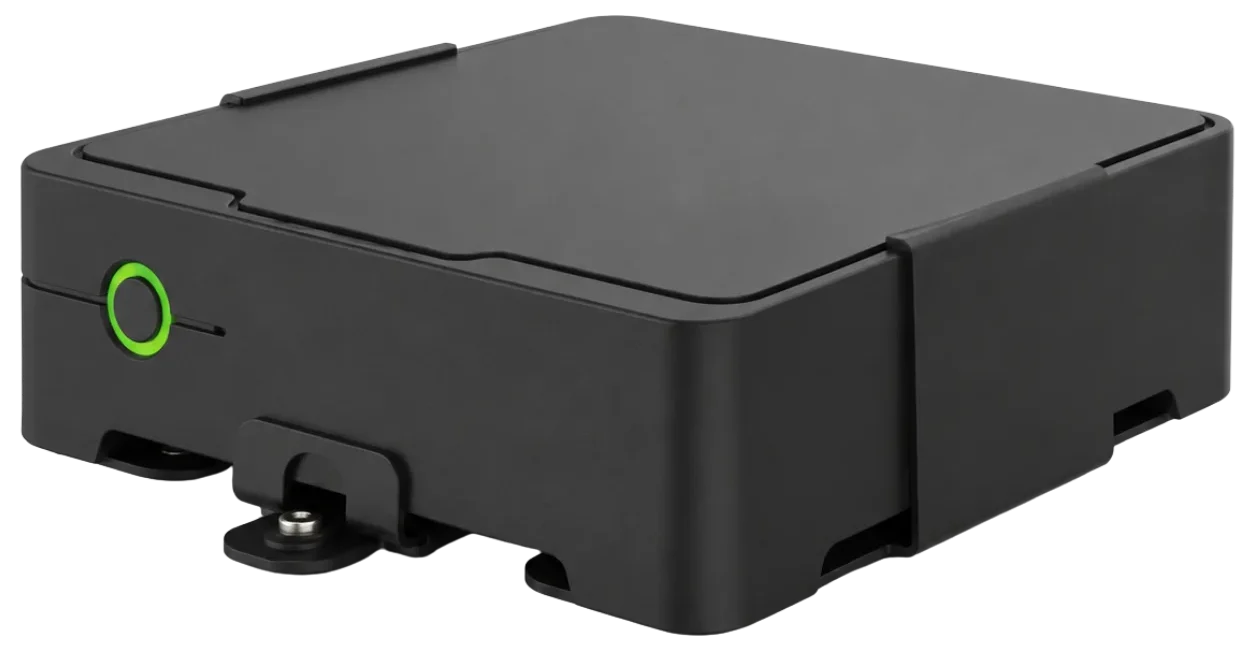 Angled view of the AXIS W800 System Controller showing black casing, green button, and mounting feet.
