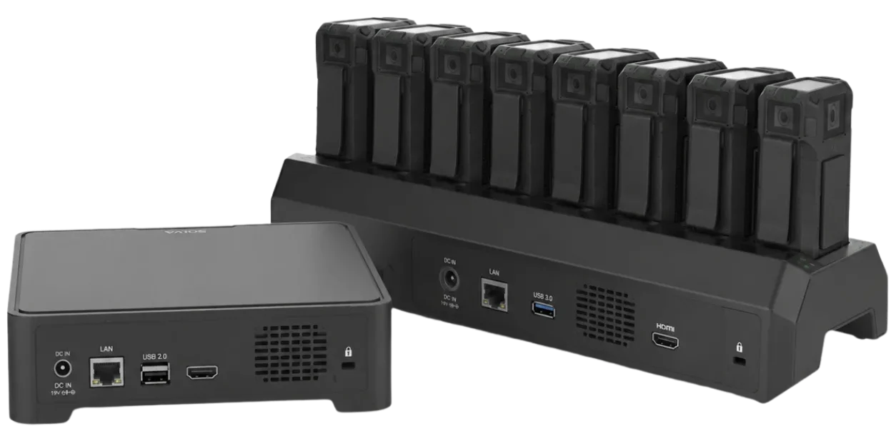 Genetec body-worn cameras docked for charging, secure video upload, and unified evidence management.