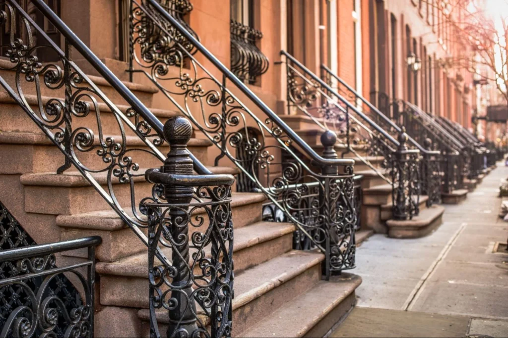 Brownstone-buildings-with-ornate-ironwork-in-a-safe-New-York-neighborhood.
