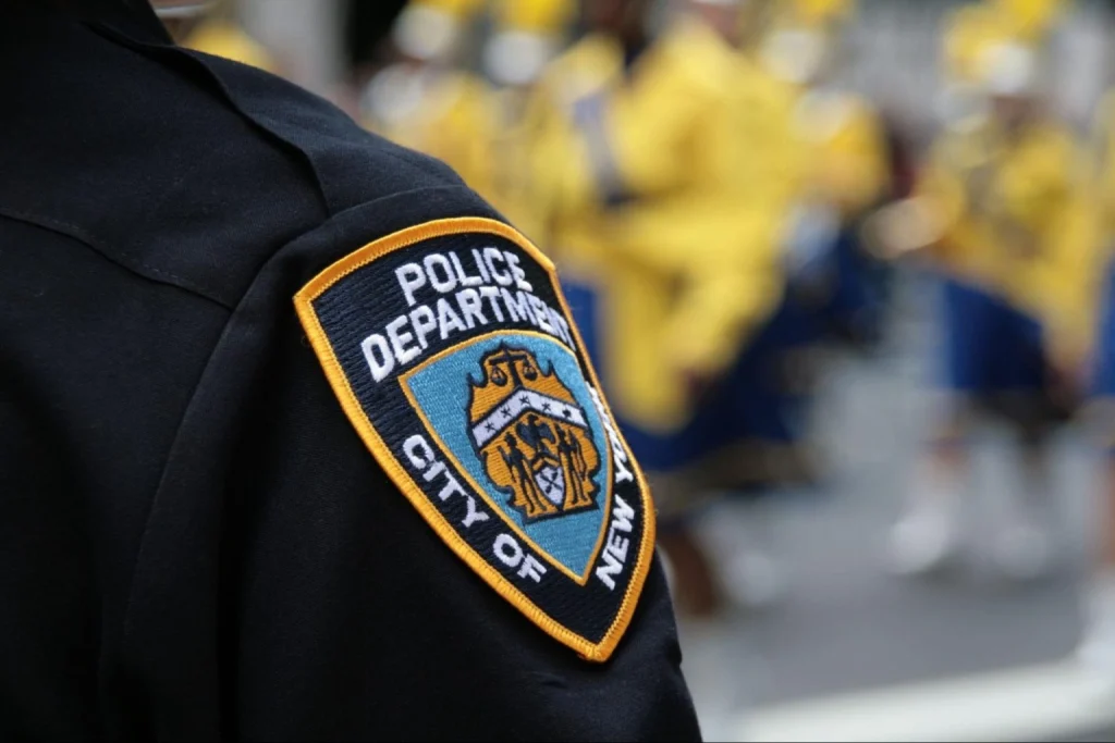 Close-up-of-NYPD-officers-uniform-with-badge-during-a-public-event