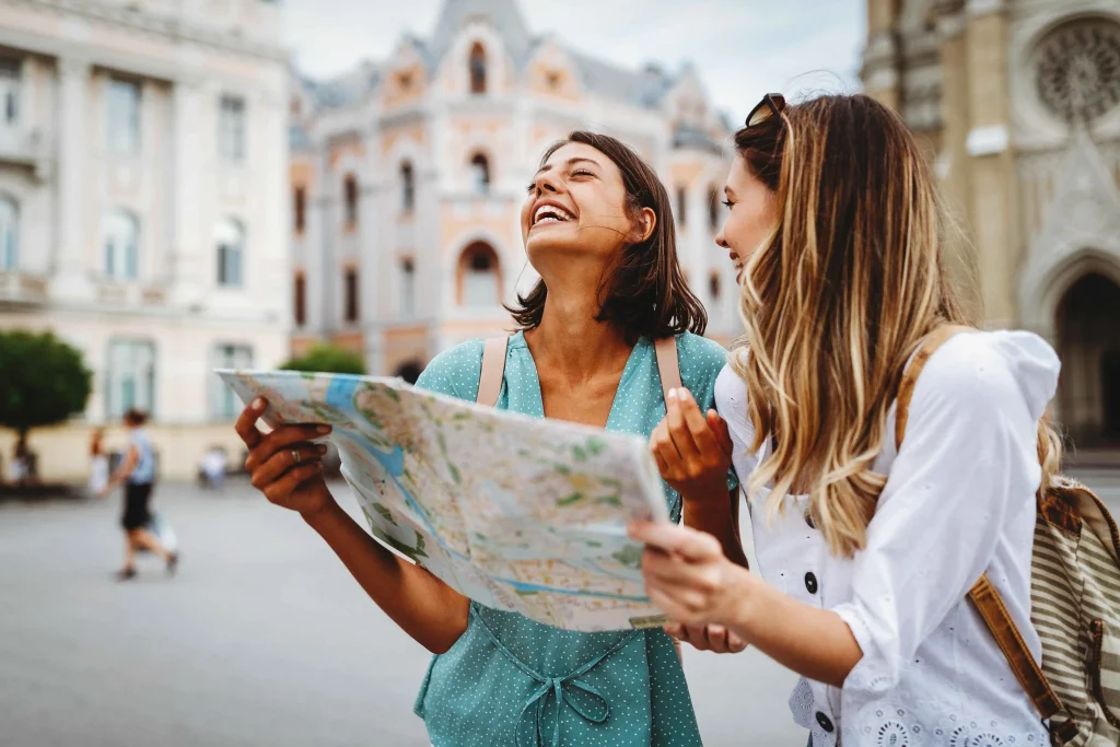 Two women holding a map while exploring Minneapolis city streets safely in 2025.