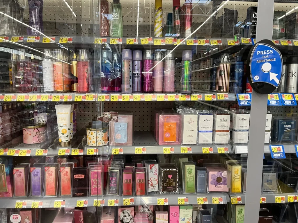 Locked retail display with fragrances and press for assistance button for theft prevention security