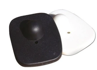 Magnetic retail security tags in black and white used for clothing and merchandise theft protection