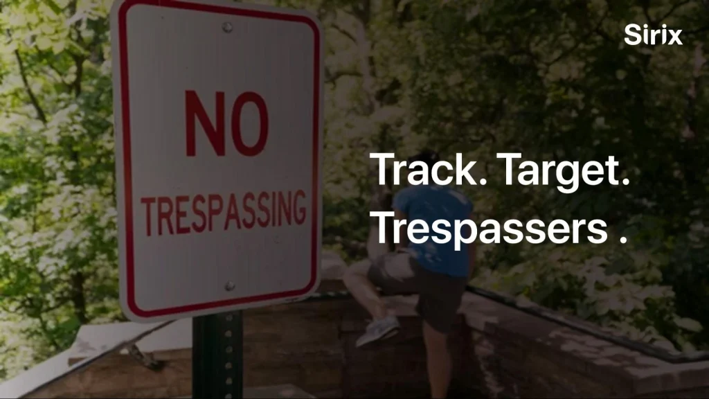 Trespasser climbing over a 'No Trespassing' sign.