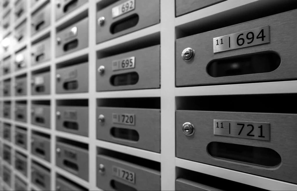 Row of mailboxes in a multi-family residence hallway.
